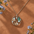 3 Butterflies necklace on terracotta with blue flowers