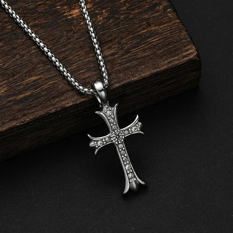 Silver-tone cross necklace with sparkling accents against dark wood