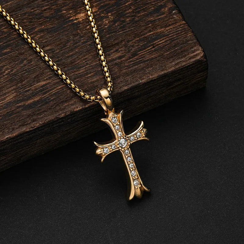Gold-tone cross necklace with sparkling accents against dark wood