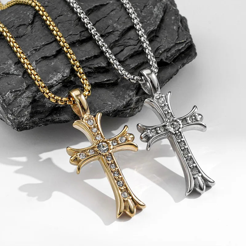 Gold-tone and silver-tone Dominion Cross necklaces displayed against dark stone