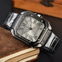 A rectangular metal wristwatch with a dark gunmetal bracelet and a silver-toned dial featuring Roman numerals, resting on an old book.