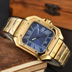 A gold-tone metal watch with a blue dial and Roman numeral hour markers, resting on a brown leather surface.