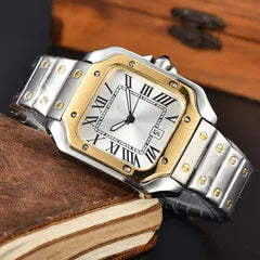 A two-tone stainless steel and gold watch with a silver and white dial, resting on a vintage book with a wooden background.