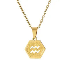 A gold hexagonal pendant necklace featuring a cutout astrological symbol for Libra, suspended from a delicate gold chain against a plain white background.