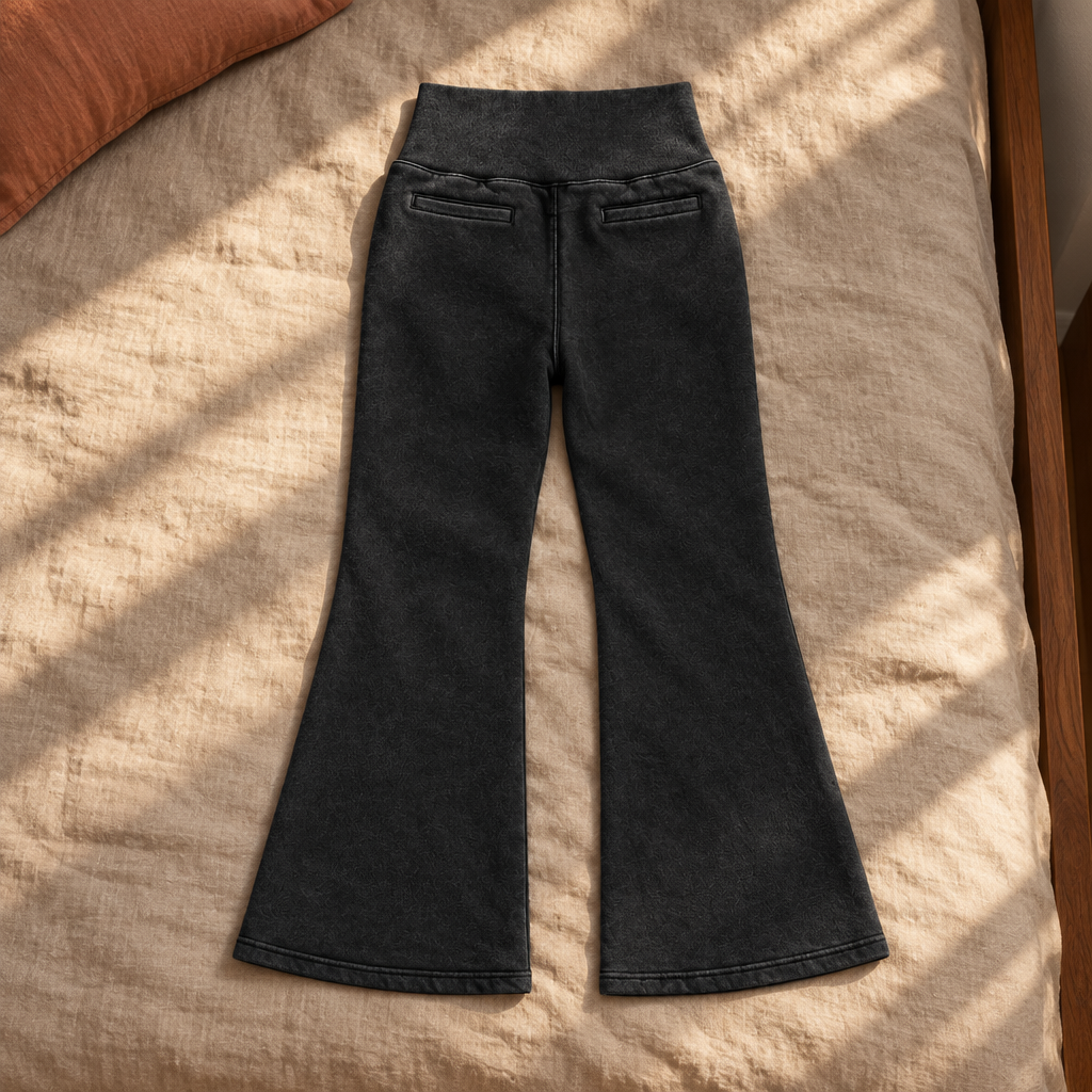 Black flared fleece pants back on sunlit bedding