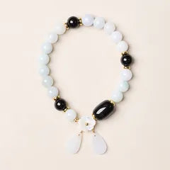 Pale beaded bracelet with black accent beads