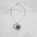 Blue Botanical Resin Pendant on White Marble