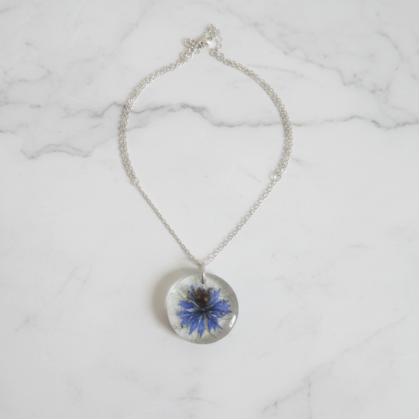 Blue Botanical Resin Pendant on White Marble