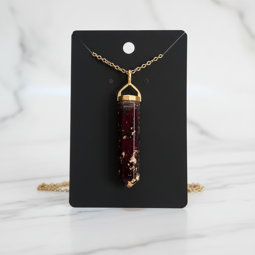 Burgundy resin necklace on white marble