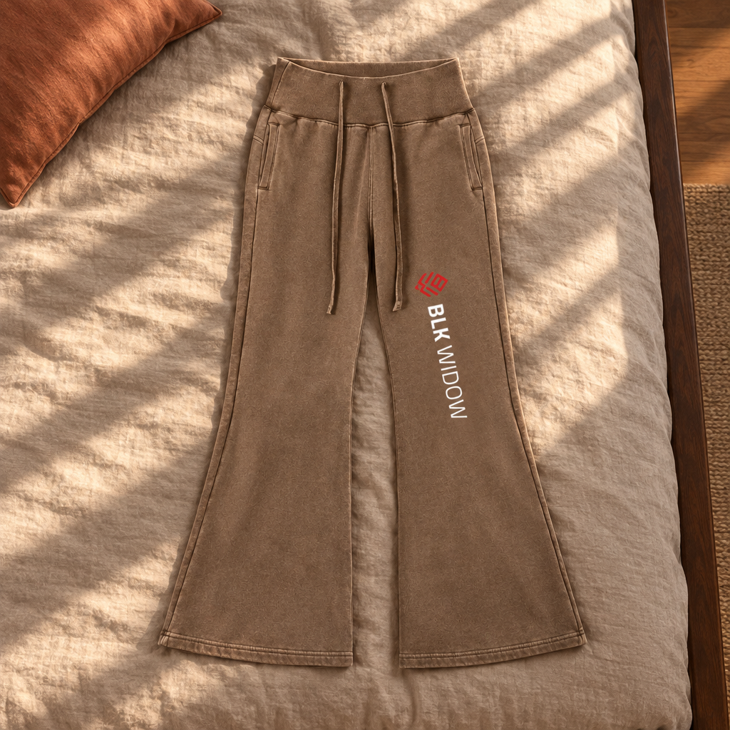 Coffee-brown flared fleece pants front on sunlit bedding