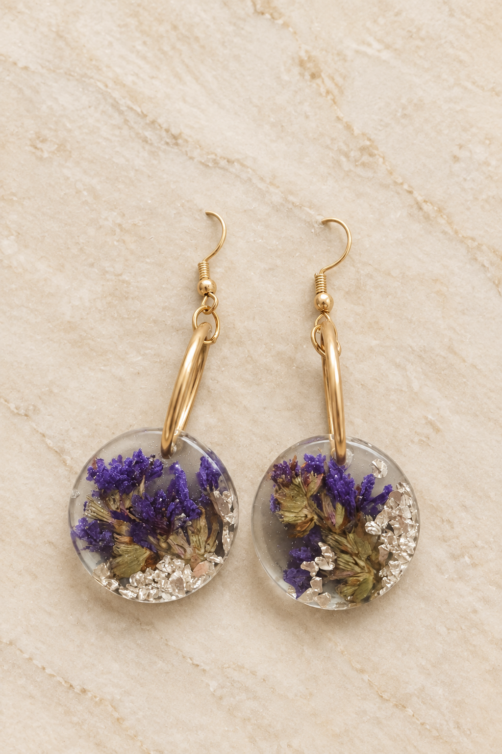 Earrings on cream stone background