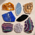 Eight decorative crystal slices arranged together on warm taupe stone