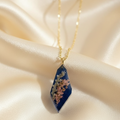Elongated rhombus translucent navy pendant on cream silk