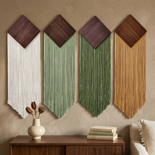 Four wall hangings above a walnut console in a bohemian interior