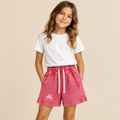 Girl wearing pink snow-washed BlkWidow shorts