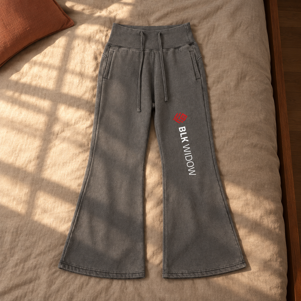 Grey flared fleece pants front on sunlit bedding