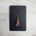 Enchanting Teardrop resin pendant necklace on marble background