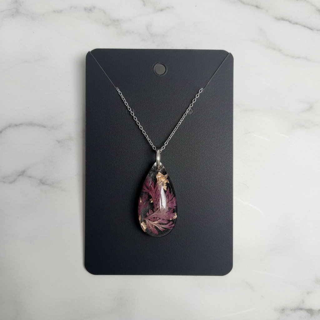 Enchanting Teardrop resin pendant necklace on marble background