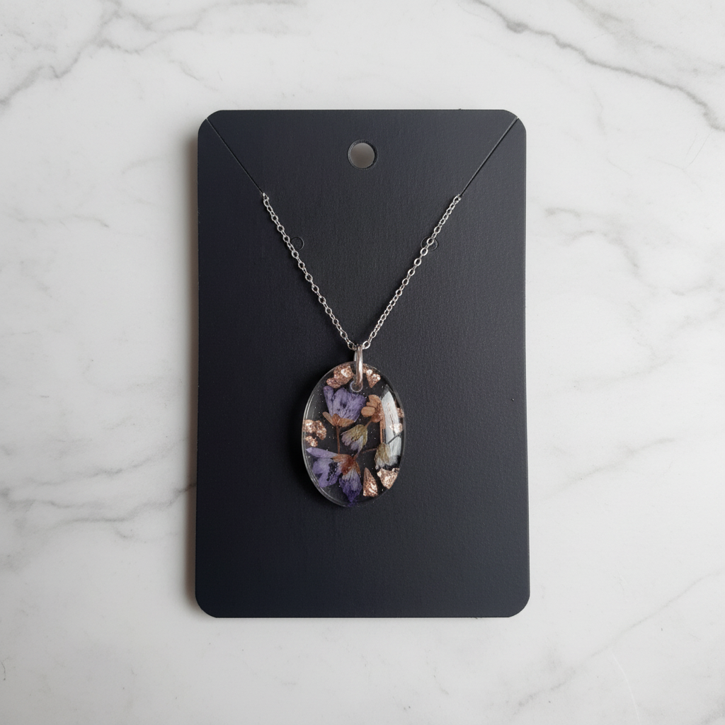 Ocean God Teardrop resin necklace on marble background