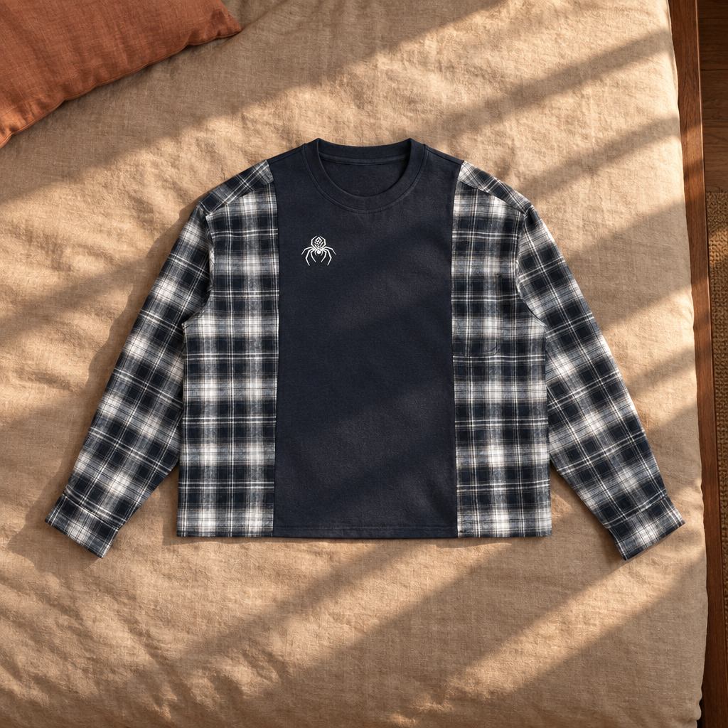 Navy plaid-panel T-shirt front on sunlit bedding