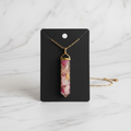 Pink white resin pendant on white marble