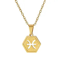 A gold hexagonal pendant necklace featuring the Pisces zodiac symbol, displayed on a clean white background.