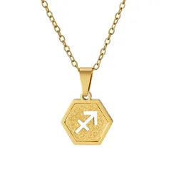 A gold hexagonal pendant necklace featuring the Libra zodiac symbol, suspended from a delicate gold chain against a plain white background.
