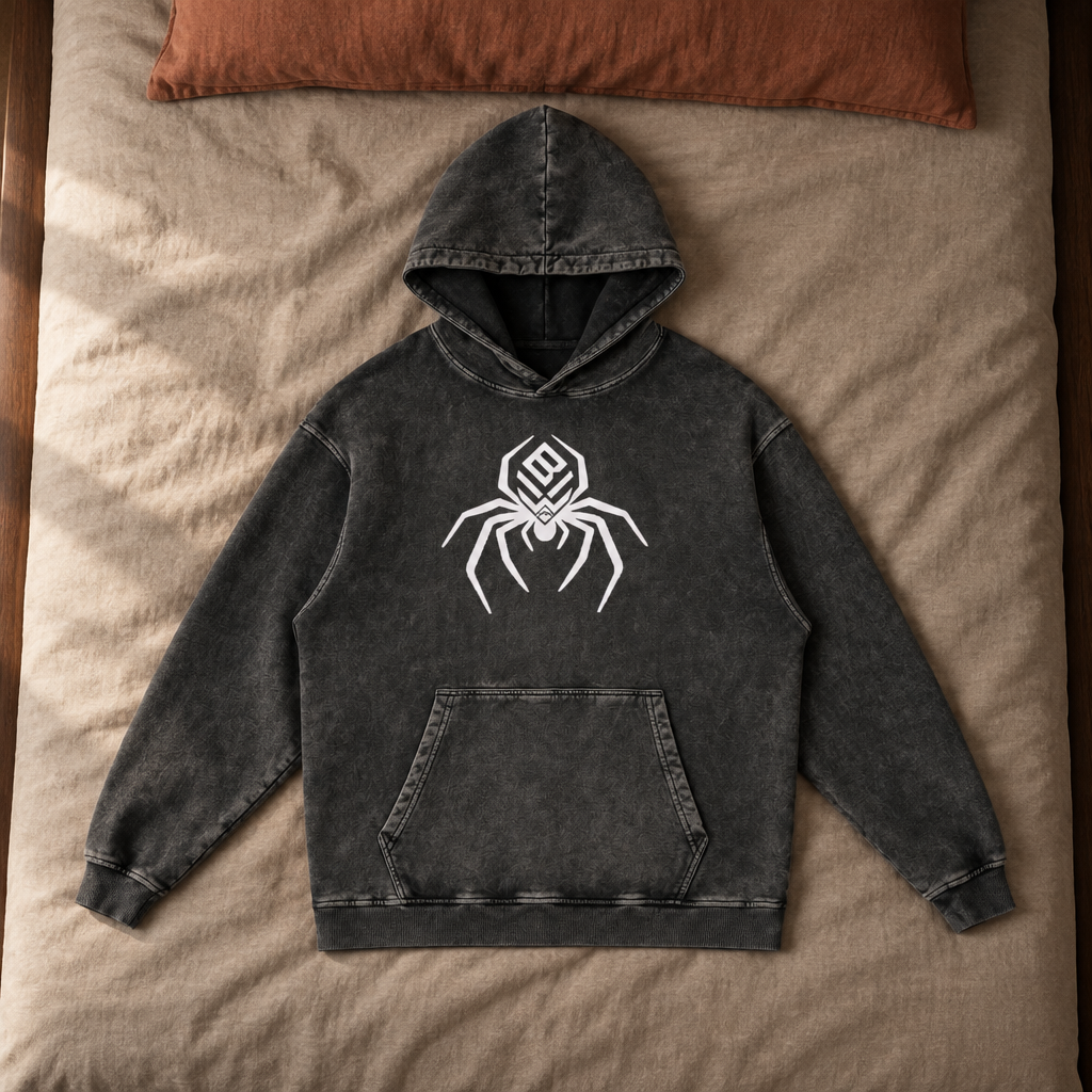 Snow Wash Hoodie front laid on luxury bedding
