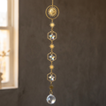 Sun-and-star suncatcher against charcoal