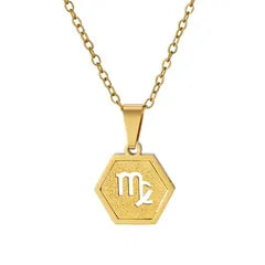 A gold hexagonal pendant necklace featuring the Libra zodiac symbol, displayed on a clean white background.